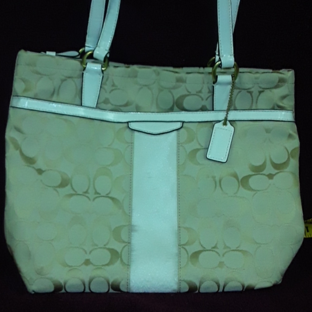 cream and gold coach handbag.